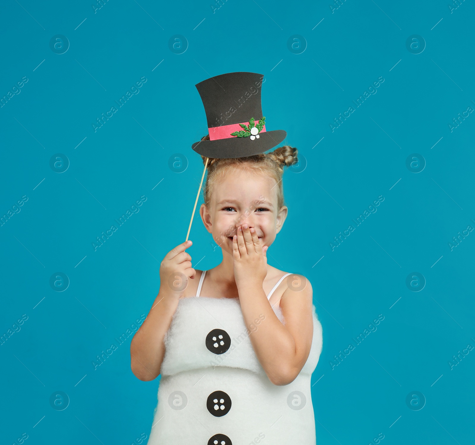 Image of Cute little girl dressed as snowman on light blue background. Christmas suit