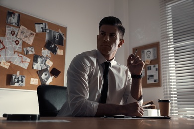 Detective working at desk in his office