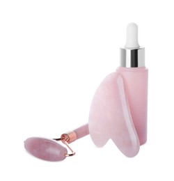 Photo of Rose quartz gua sha tool, facial roller and bottleserum isolated on white