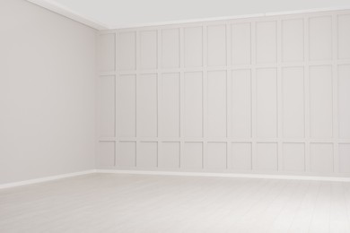 Photo of Empty room with beige walls and laminated flooring