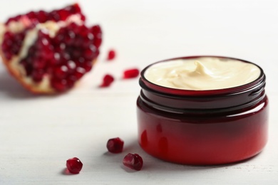 Photo of Closeup view of hand cream jar on wooden background