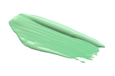 Photo of Stroke of green color correcting concealer isolated on white