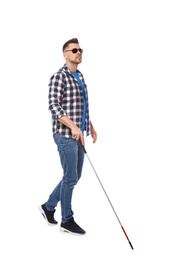 Photo of Blind man in dark glasses with walking cane on white background