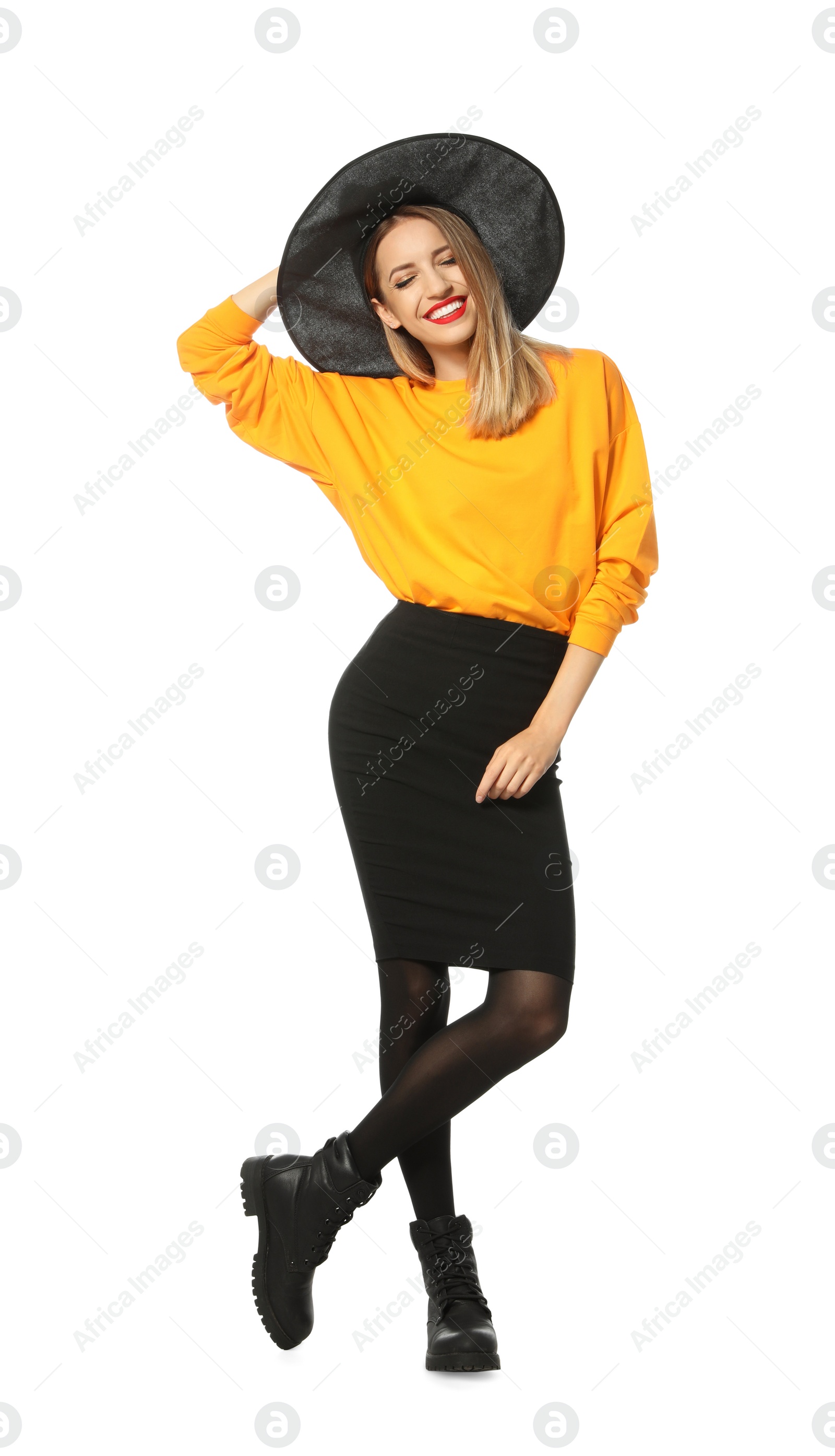 Photo of Beautiful young woman wearing witch costume for Halloween party on white background