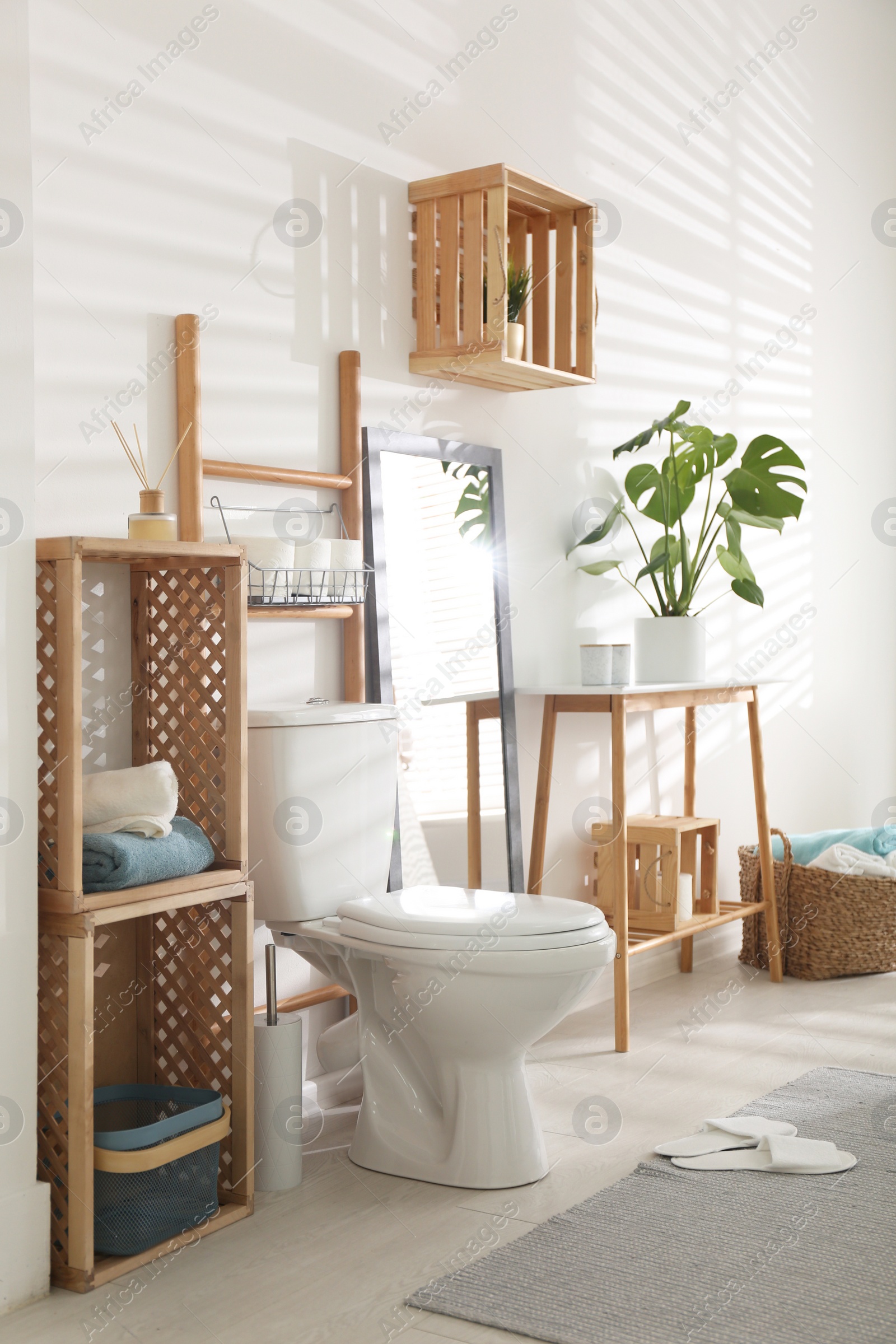 Photo of Interior of stylish bathroom with toilet bowl and decor elements