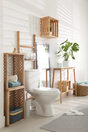 Photo of Interior of stylish bathroom with toilet bowl and decor elements