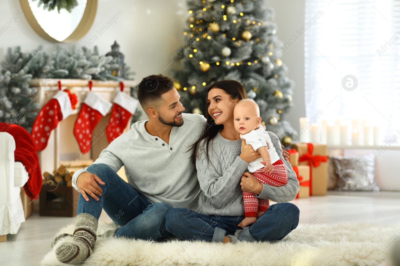 Photo of Happy family with cute baby at home. Christmas celebration