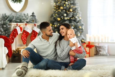 Happy family with cute baby at home. Christmas celebration