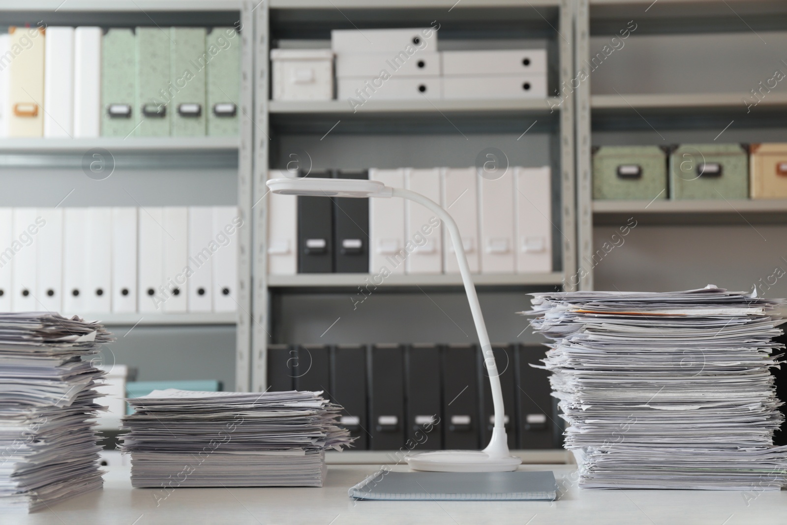 Photo of Stacks of documents on table in office