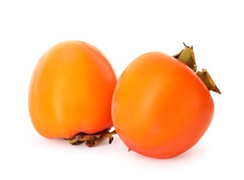 Delicious ripe juicy persimmons on white background