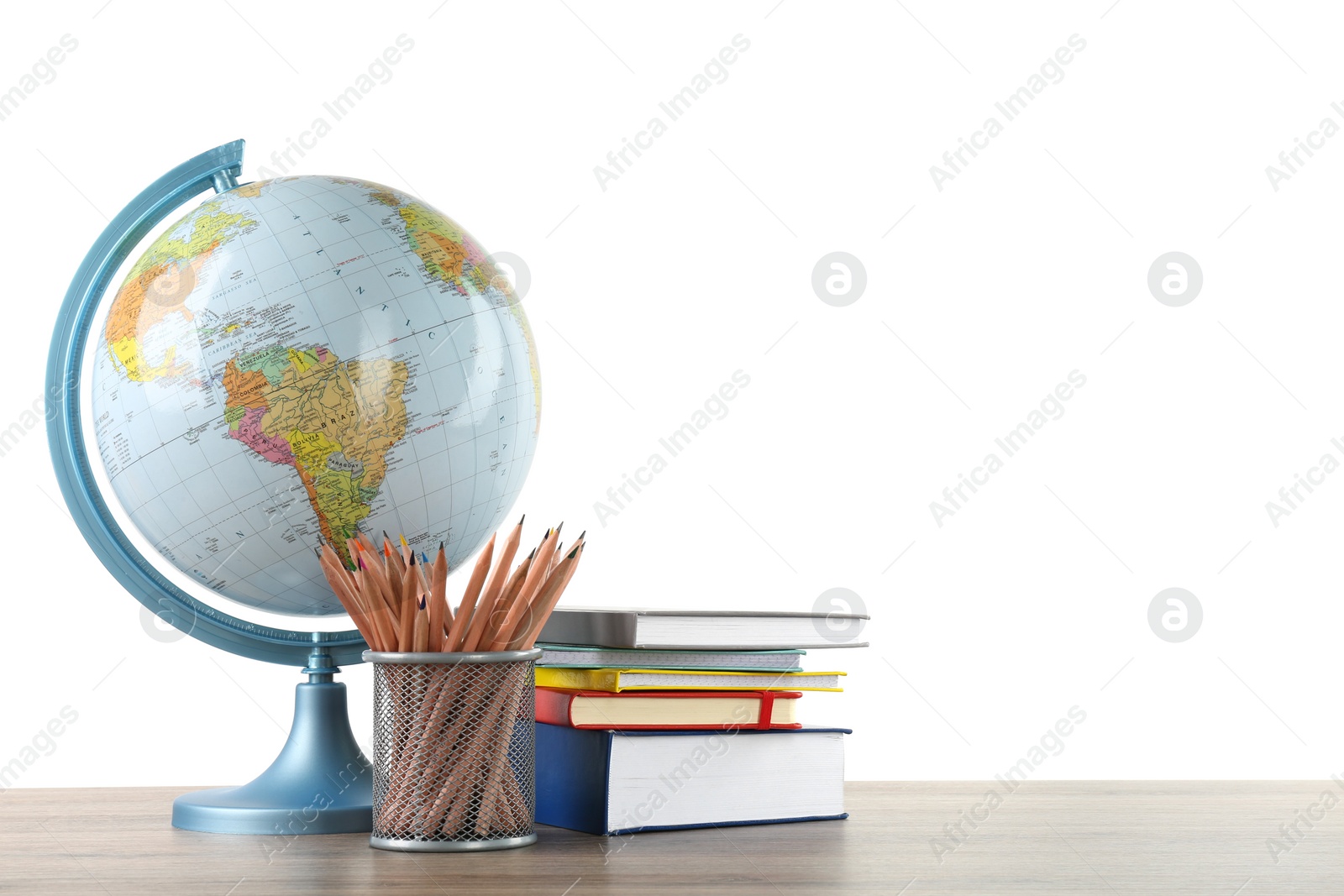 Photo of Globe, school supplies and books on wooden table against white background. Geography lesson