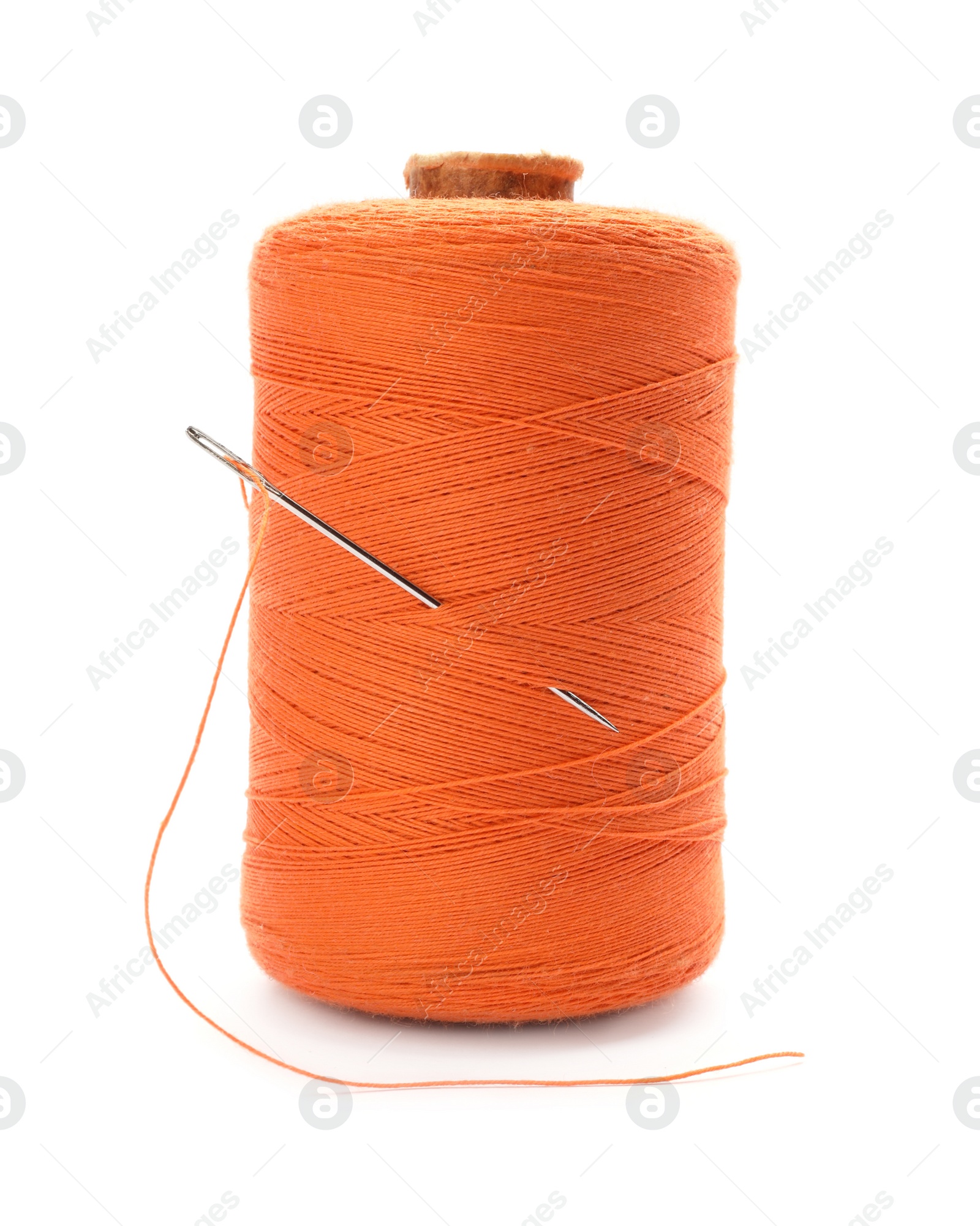 Photo of Orange sewing thread with needle on white background