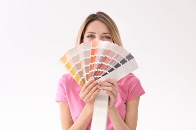 Young woman with color palette on white background