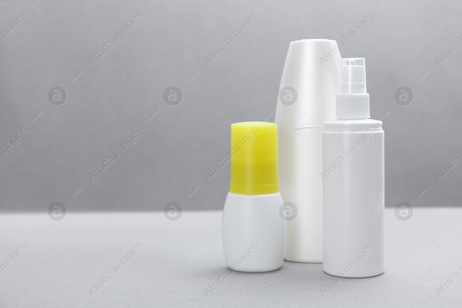 Photo of Set of different insect repellents on grey background. Space for text