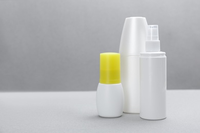 Photo of Set of different insect repellents on grey background. Space for text