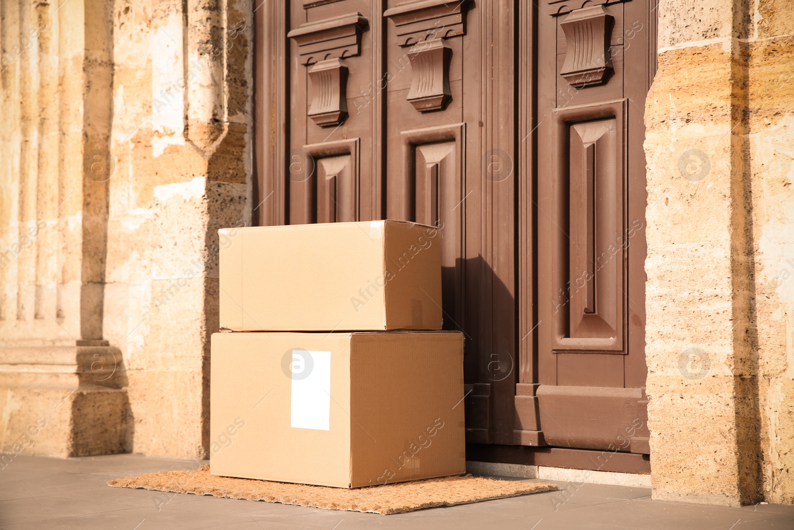 Photo of Delivered parcels on door mat near entrance