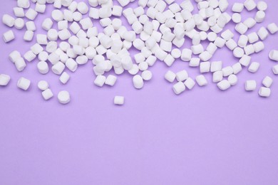 Photo of Delicious sweet marshmallows on purple background, flat lay. Space for text