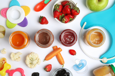 Flat lay composition with baby food, ingredients and accessories on white background