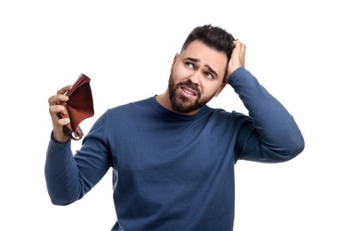 Confused man showing empty wallet on white background