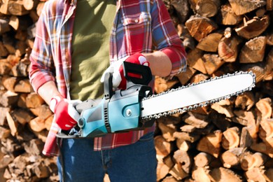 Photo of Man with modern saw on sunny day, closeup