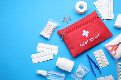 Photo of Flat lay composition with first aid kit on light blue background. Space for text