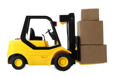 Photo of Toy forklift with boxes isolated on white. Logistics and wholesale concept