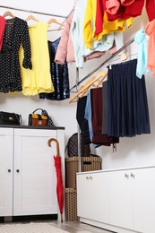 Modern dressing room with different stylish clothes and accessories