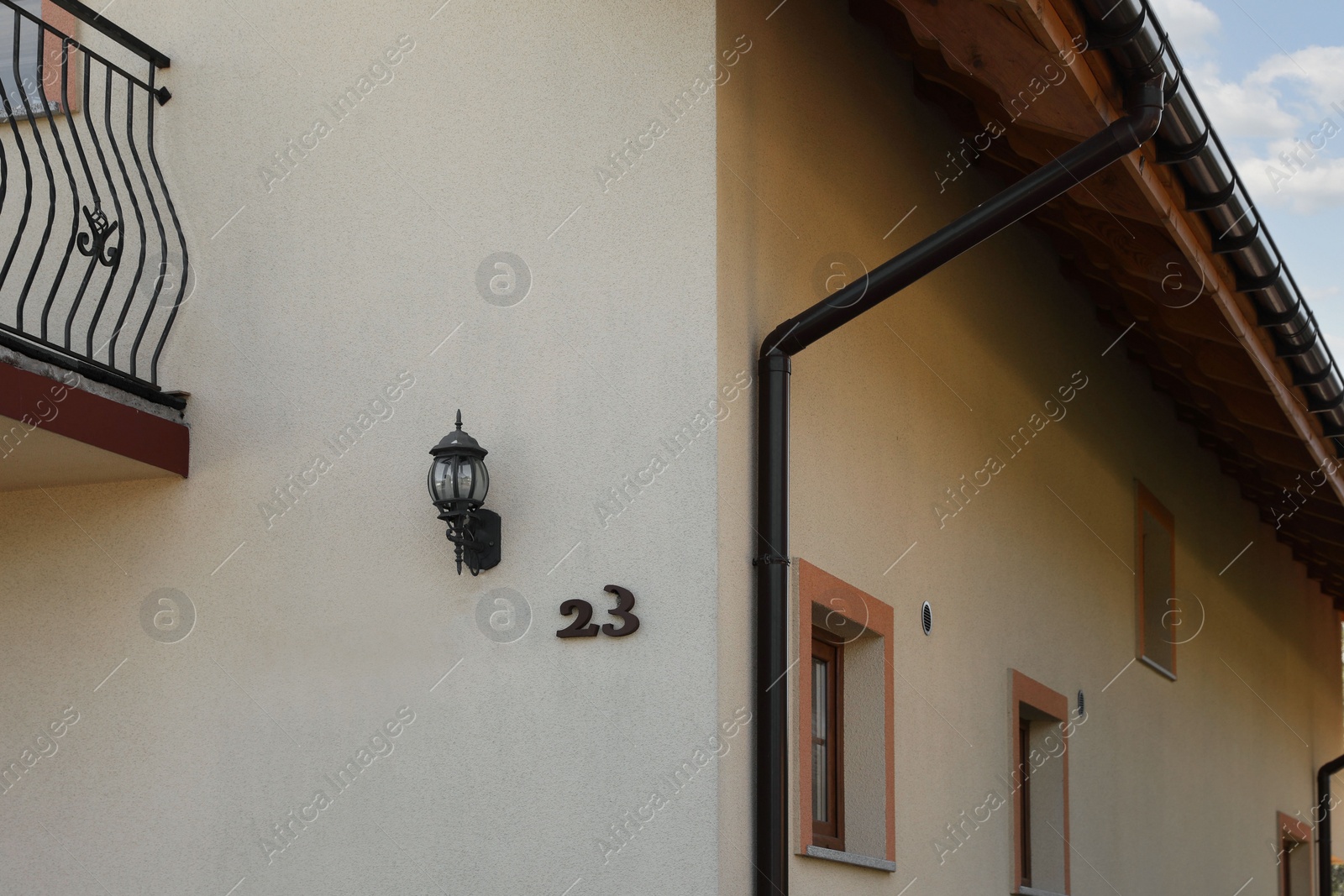 Photo of Number 23 on yellow house with balconies outdoors