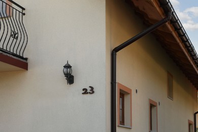 Photo of Number 23 on yellow house with balconies outdoors