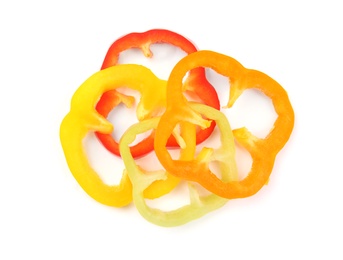 Rings of ripe bell peppers on white background, top view