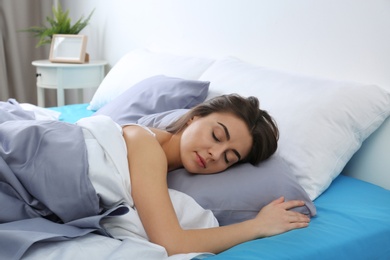 Young woman sleeping on soft pillow at home. Bedtime