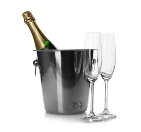 Bottle of champagne in bucket and glasses on white background