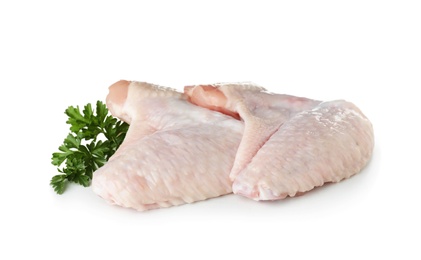 Raw chicken wings with parsley on white background. Fresh meat