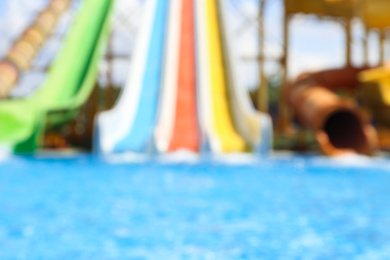 Different colorful slides in water park, blurred view