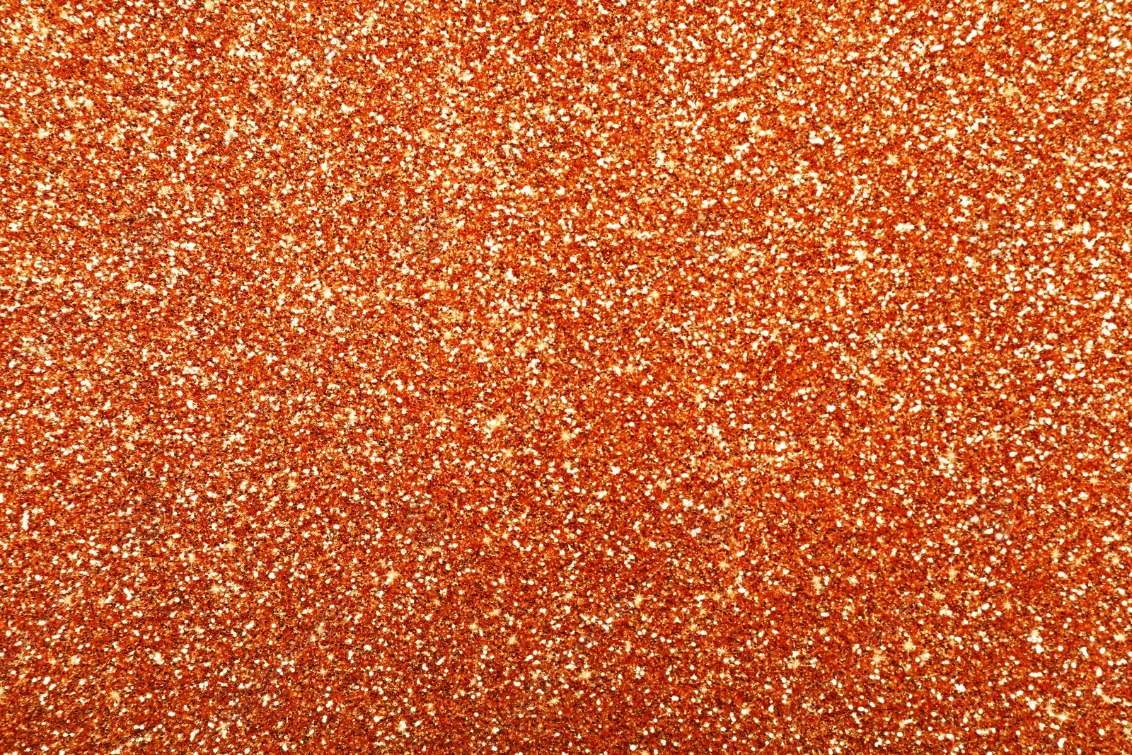 Image of Beautiful shiny orange glitter as background, closeup