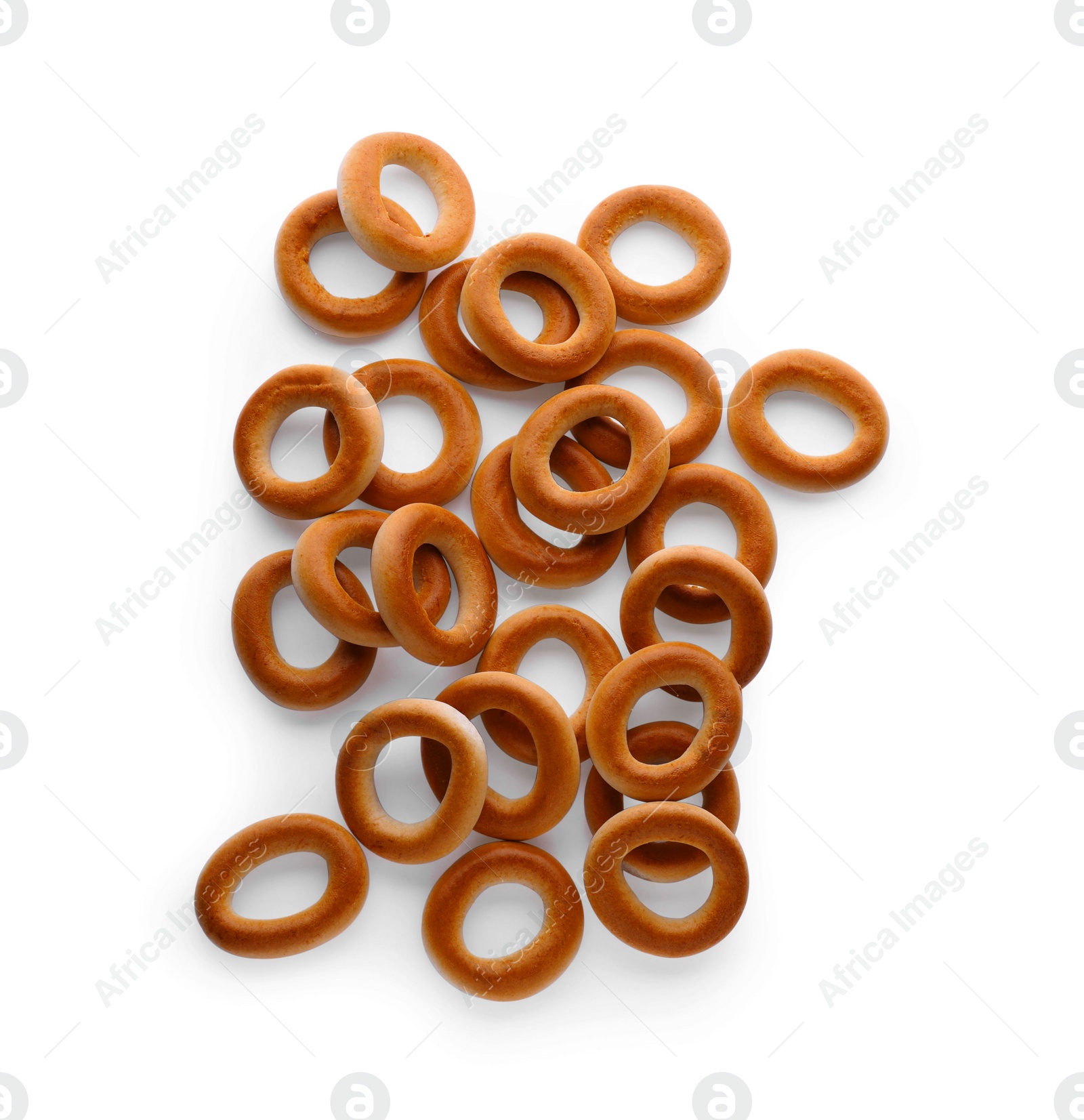 Photo of Many tasty dry bagels (sushki) isolated on white, top view