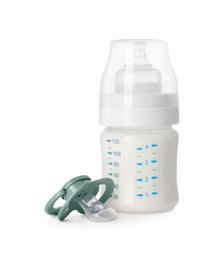 Photo of Bottle with milk and baby pacifier isolated on white