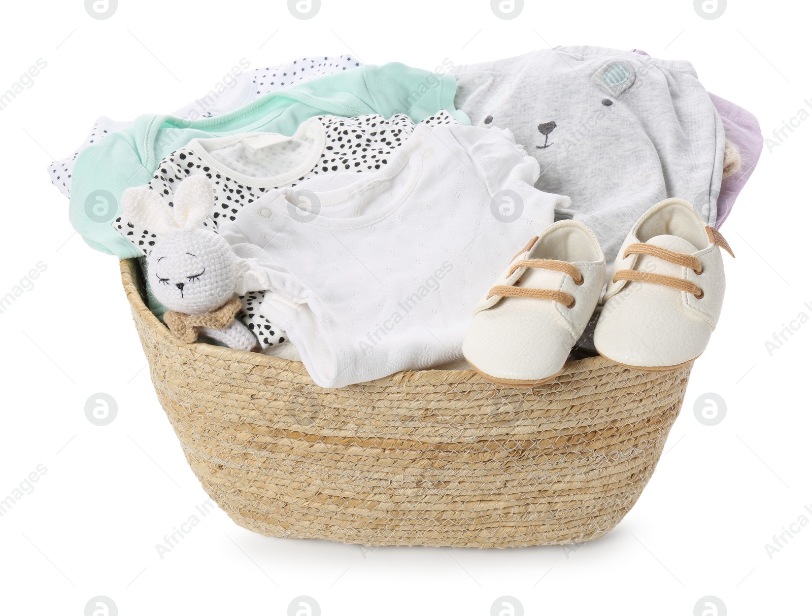 Photo of Laundry basket with baby clothes, shoes and toy isolated on white