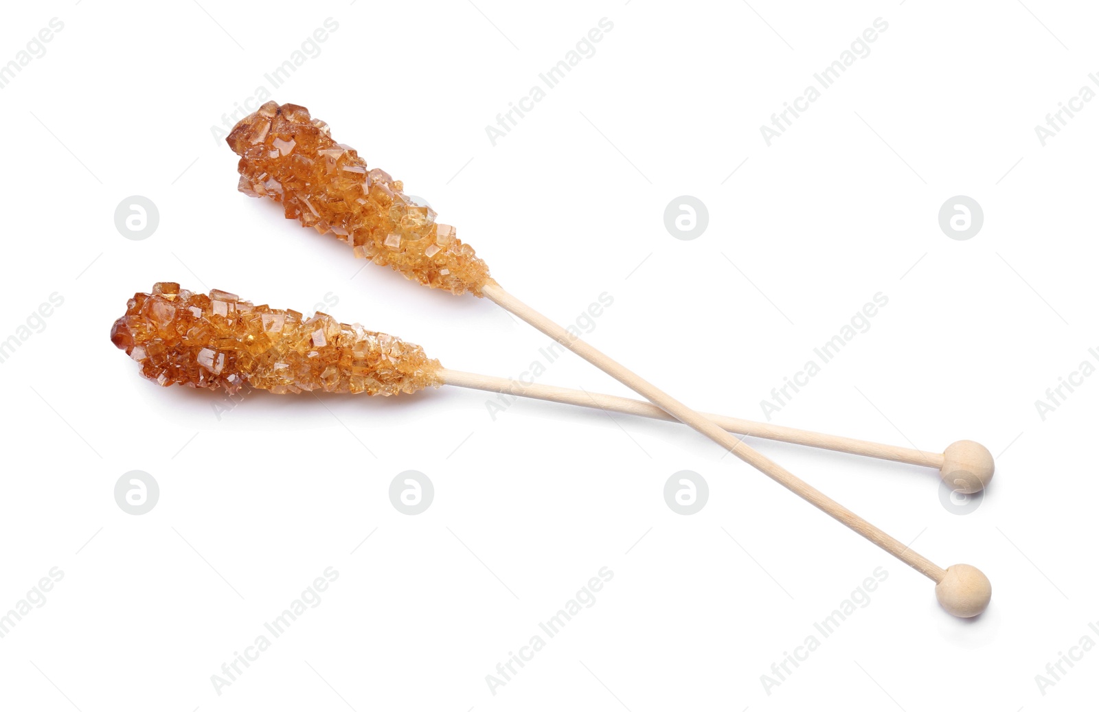 Photo of Wooden sticks with sugar crystals isolated on white, top view. Tasty rock candies