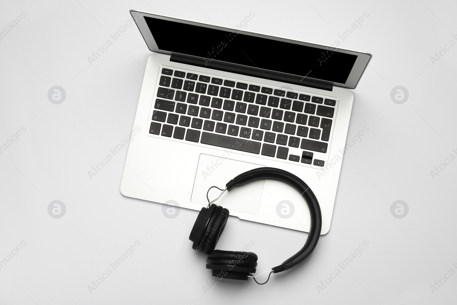 Photo of Modern headphones and laptop on white background, top view