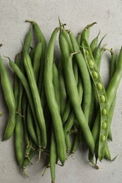 Photo of Fresh green beans on light grey table, flat lay