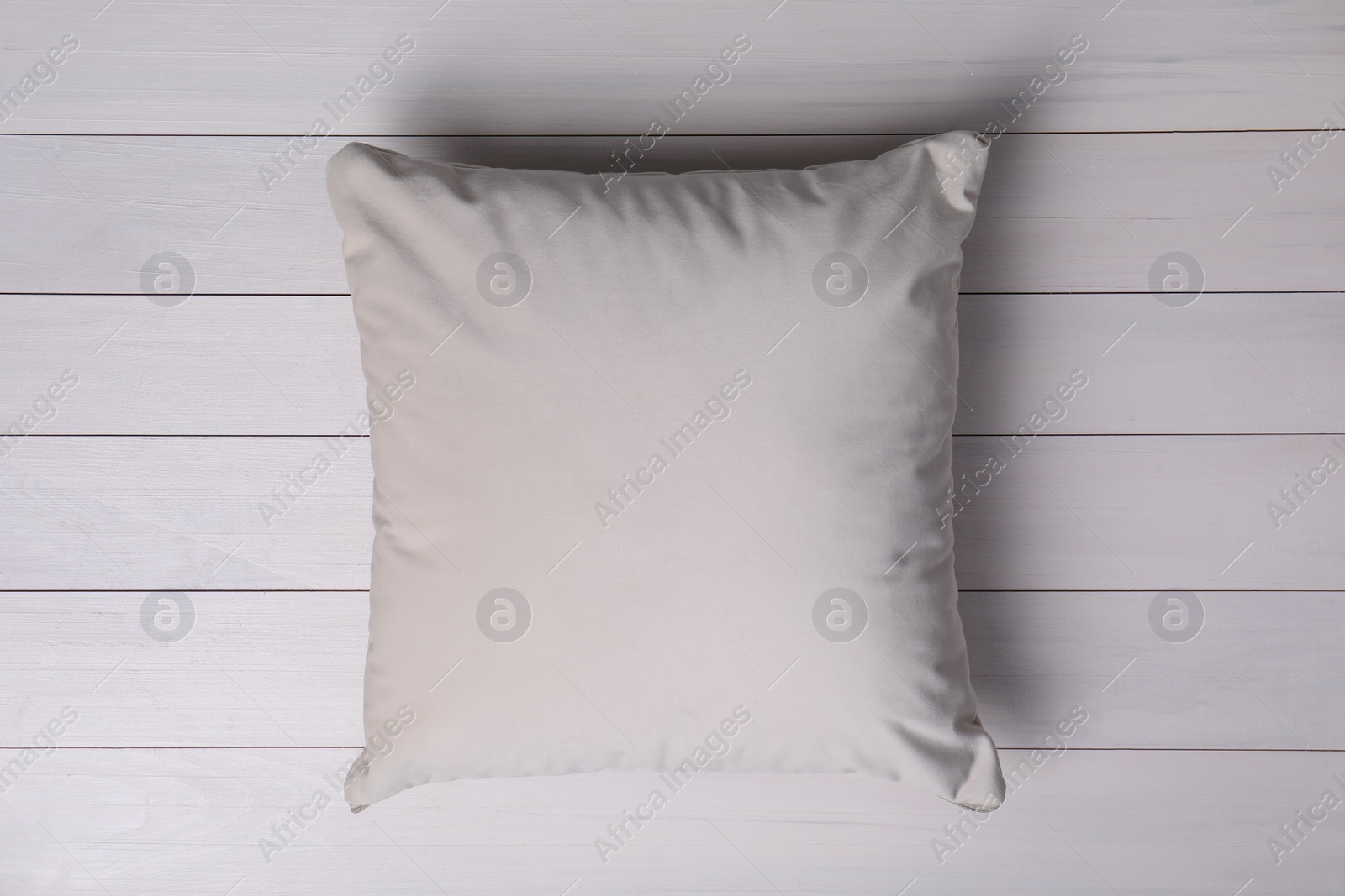 Photo of Blank soft pillow on white wooden background, top view
