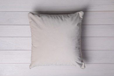 Blank soft pillow on white wooden background, top view