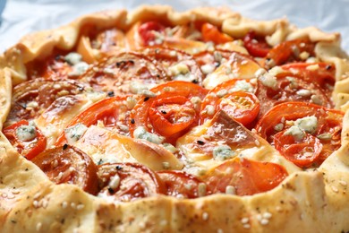 Tasty galette with tomato and cheese (Caprese galette) as background, closeup