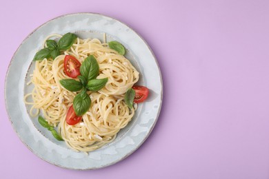 Photo of Delicious pasta with brie cheese, tomatoes and basil leaves on violet background, top view. Space for text