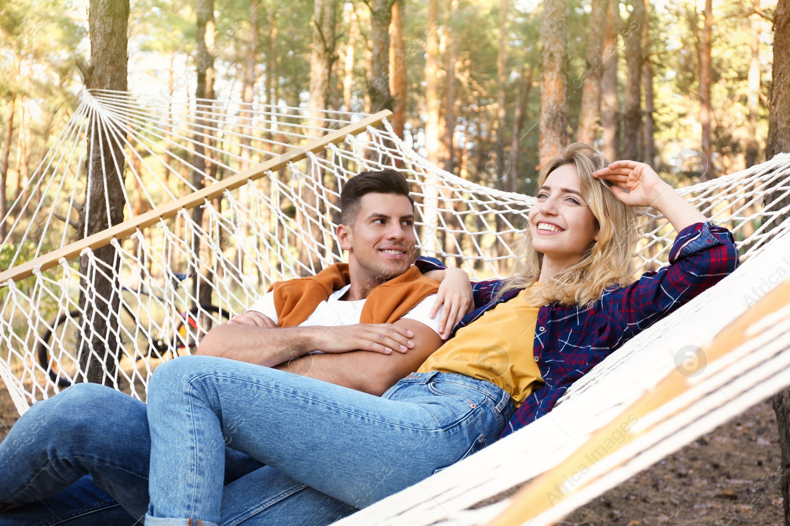 Photo of Happy couple resting in hammock outdoors on summer day