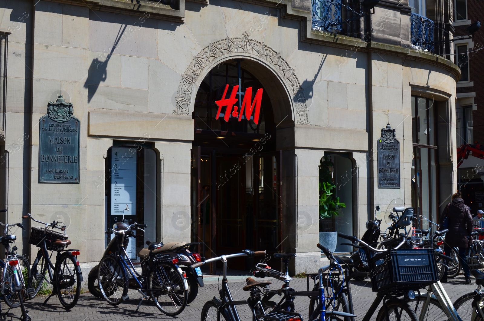 Photo of Hague, Netherlands - May 2, 2022: Exterior of H&M fashion store on city street