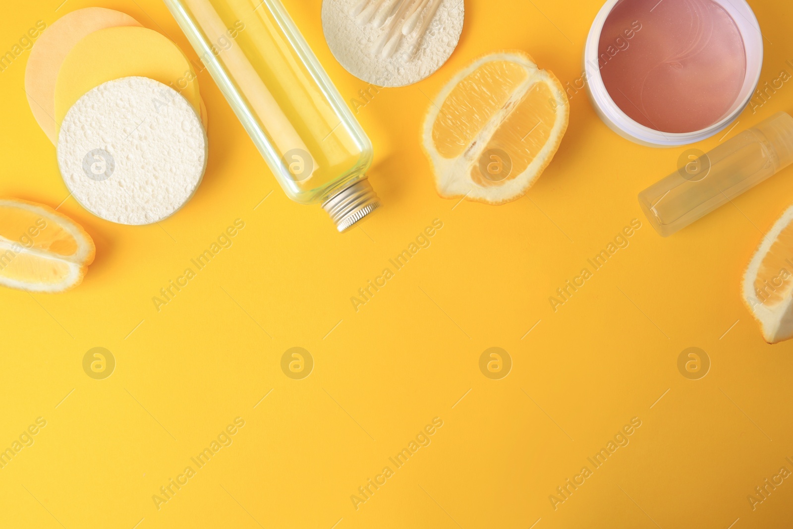 Photo of Lemon face cleanser. Fresh citrus fruits and personal care products on yellow background, flat lay with space for text