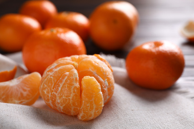 Fresh ripe tangerine on table, closeup. Citrus fruit