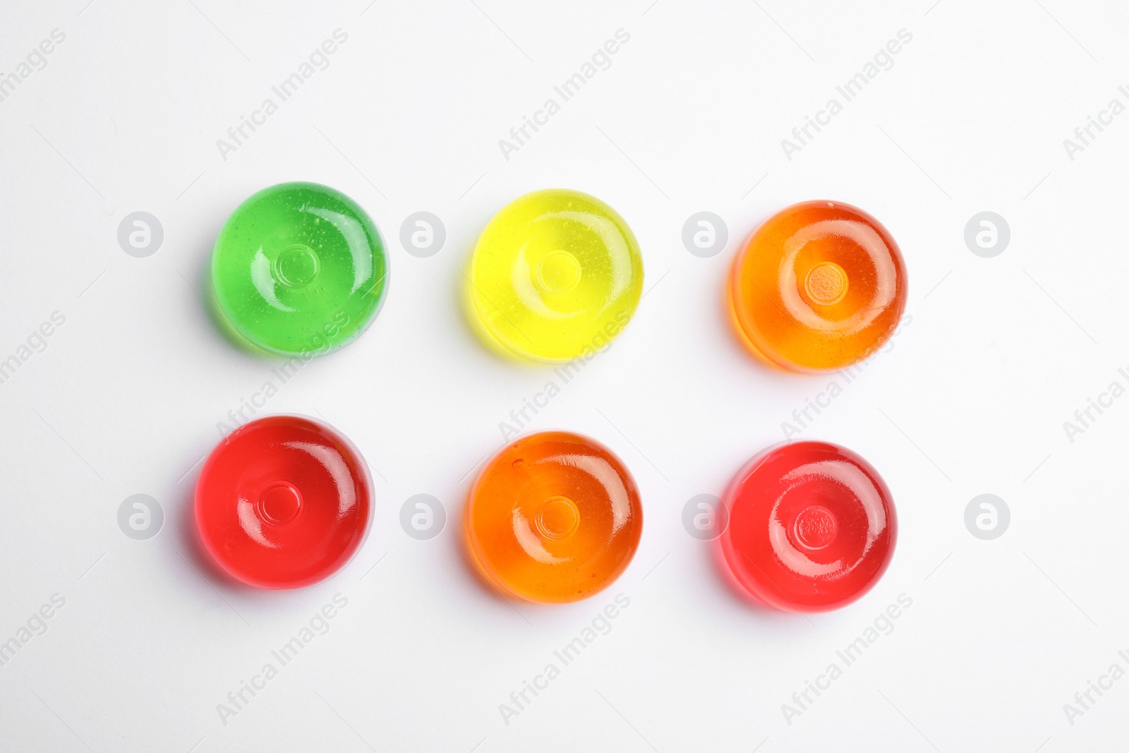 Photo of Delicious colorful candies on white background, top view